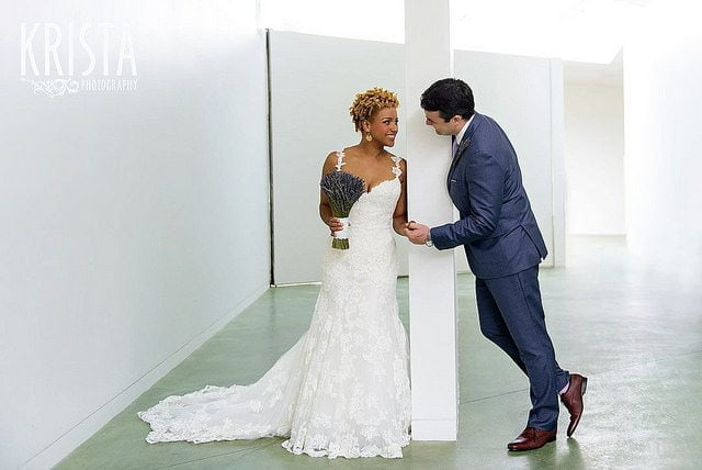 interview questions woman wearing white gown and man wearing blue suit holding one another's hand