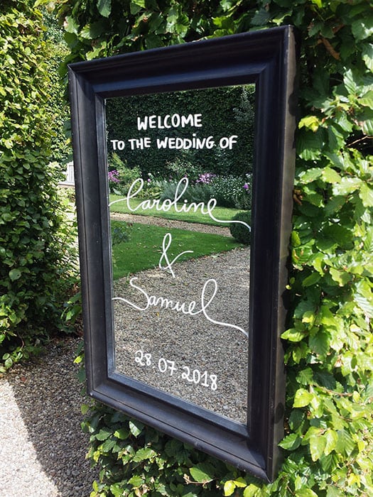 Sam and Caroline wedding a mirror with couples date of marriage printed on it