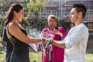 marriage officiant wofting a feather during smugding ritual