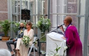 interracial weddings bride and groom laughing with the celebrant