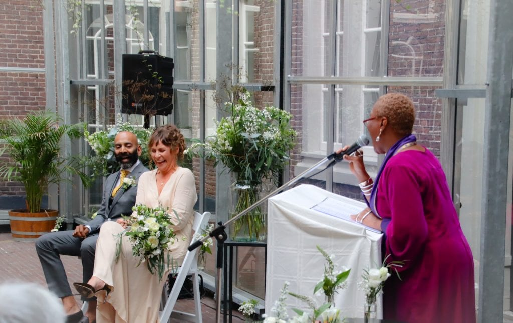 interracial bride and groom laughing with charasmatic