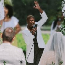 singer singing black gospel, soul and motown dressed in white and gold