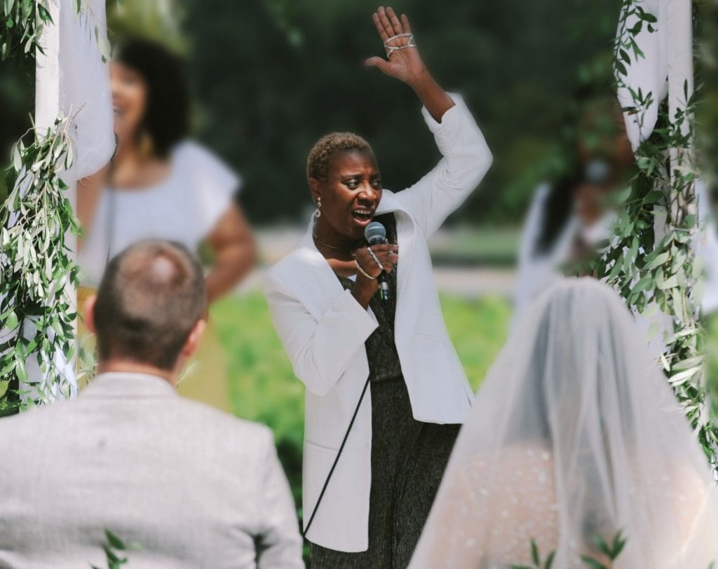 singer singing black gospel, soul and motown dressed in white and gold
