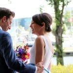 waterside wedding groom embracing bride