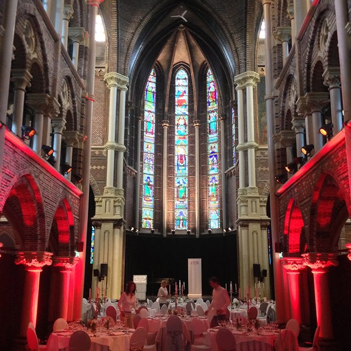 Dutch church wedding venues reception venue with tables and stain glass windows