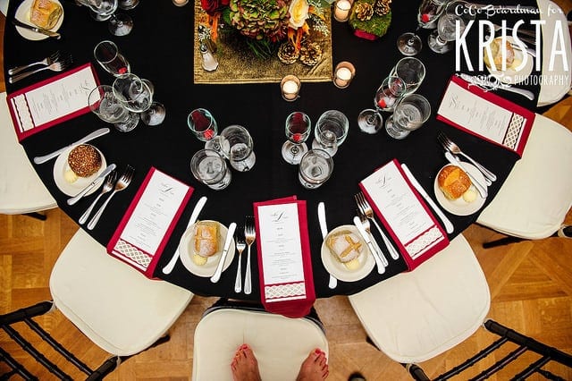 micro wedding celebration black round table with white chairs