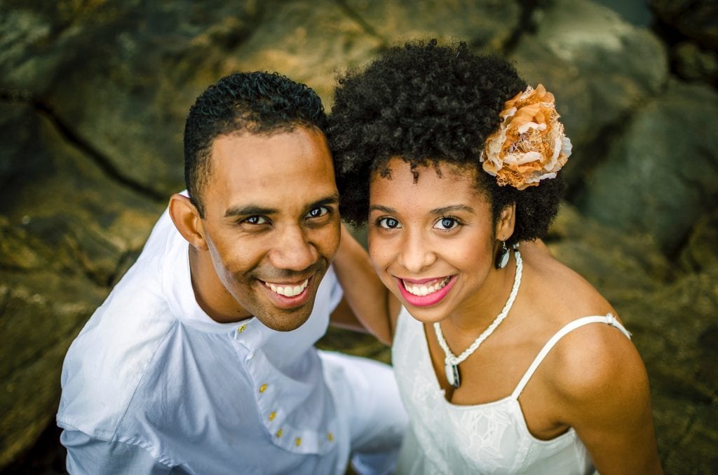 photo-of-a-man-and-woman-smiling-while-standing-on-rocks-