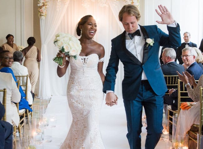 planning interracial weddings man and woman walking hand in hand down the aisle