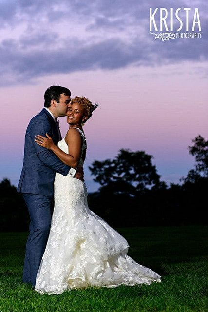 wedding planning hacks couple embracing and kissing in a park