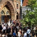Amsterdam church wedding venues newlyweds leaving building and guests looking on