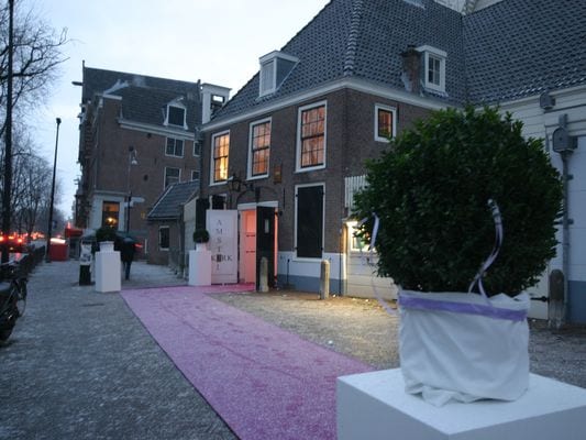 Amsterdam waterfront wedding venues pink aisle runner leading to the historic Amstelkerk