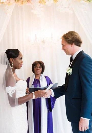 humanist wedding ceremony couple smiling and celebrant holding presentation book
