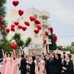 COVID-19 wedding guest List people letting go of red ballons