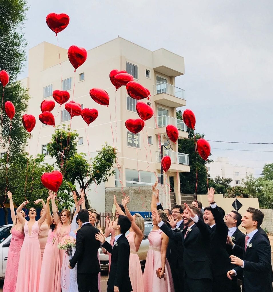 covid-19 wedding guest list people letting go of red ballons