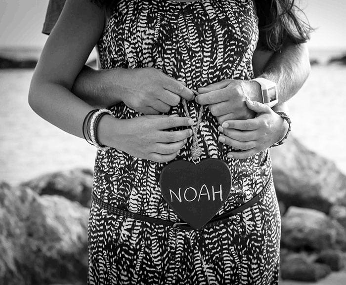 fun naming ceremony man caressing woman during her pregnancy