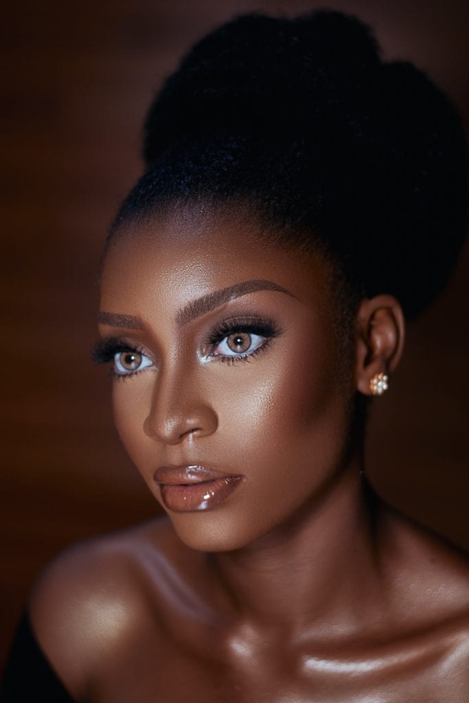  black bride with hair in a french bun and flawless makeup