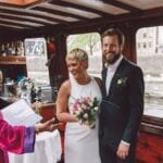 Top wedding magazines woman wearing white bridal frock holding pink and white floral bouquet