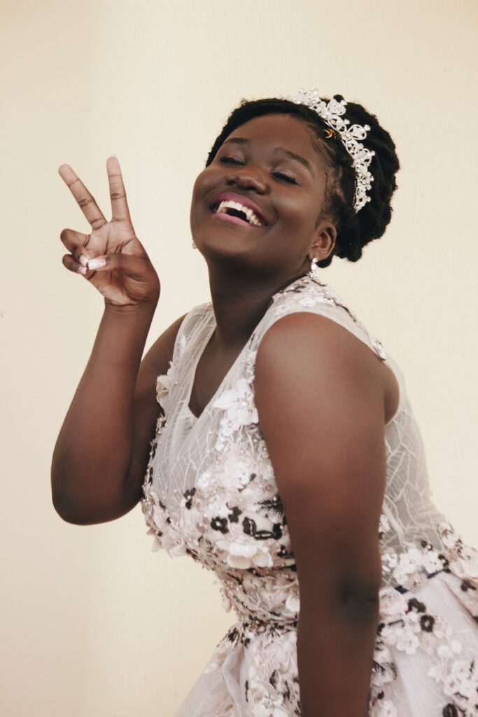 Afro Wedding Hairstyles black bride wearing a lace coloured gown and glittery crown