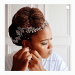 Afro wedding hairstyles black couple bride and groom kissing under arch