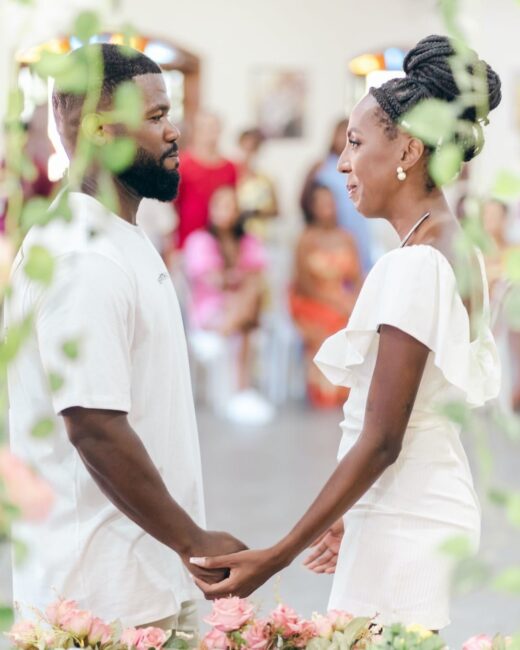 A man and a woman marry during an alternative wedding by celebrating a life partnership with a commitment ceremony featuring a ceremony speaker.