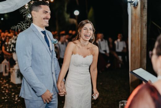 A commitment ceremony featuring a ceremony speaker where a man and woman marry.