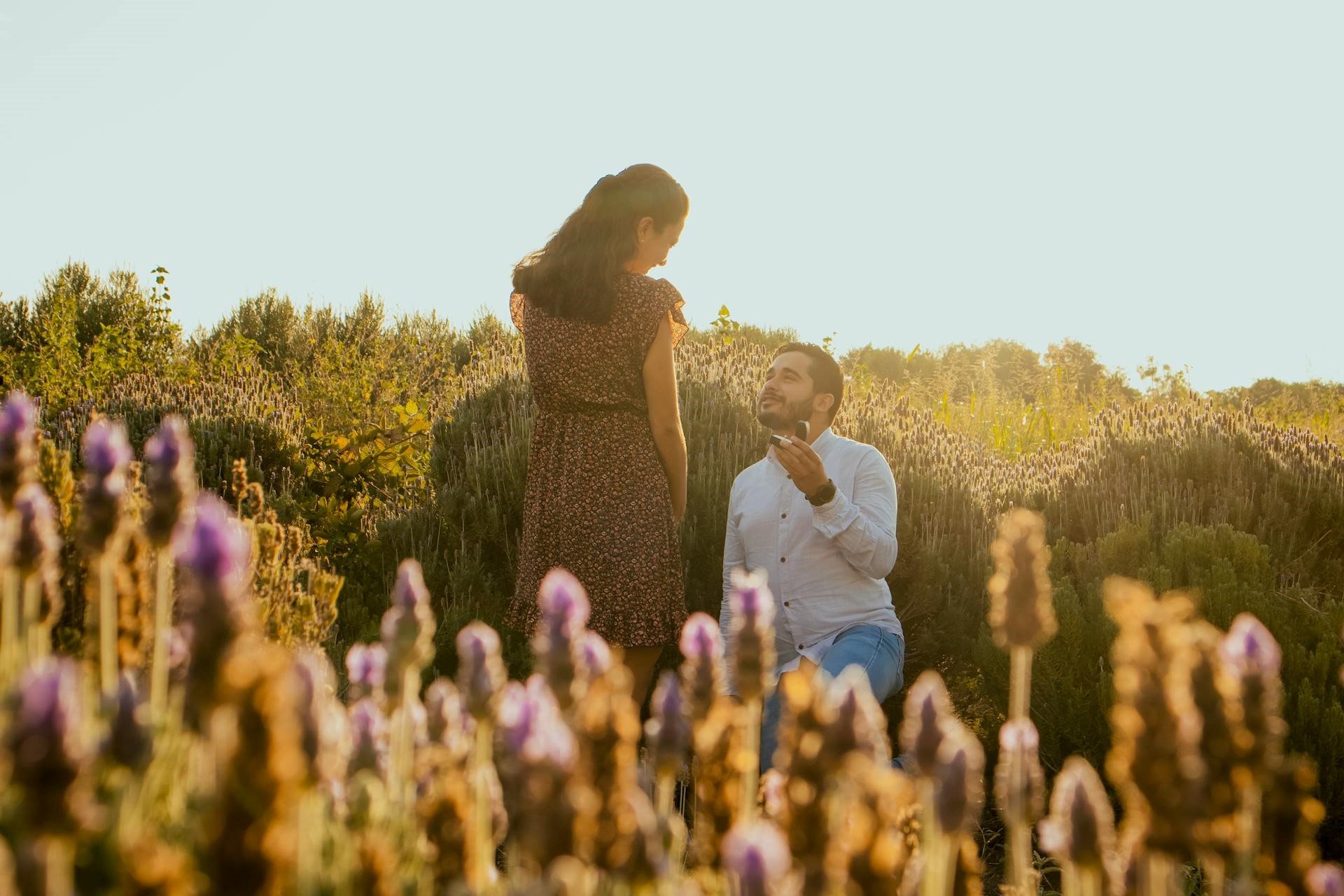 Spring marriage proposal and engagement speech man-on-knee-proposing-to-his-partner-on-a-lavender-field