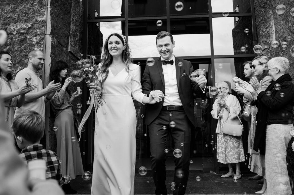 Top wedding magazines, bride & groom leave the marriage registrar's office after a civil wedding
