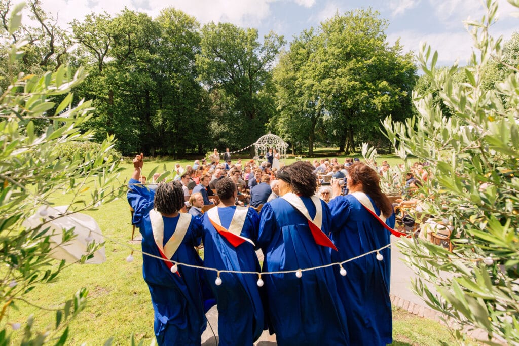Dutch wedding guide for luxury wedding couples: wedding choir singing to the bride and groom at stately home ceremony and reception venue Stania State Oentsjerk, Friesland. 