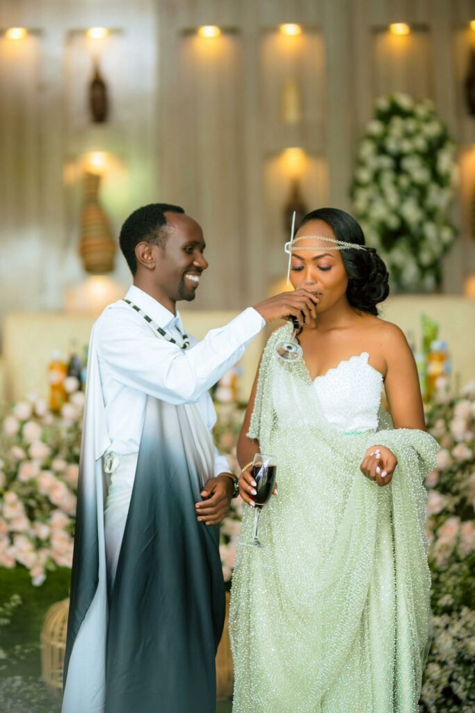 A Bride and Groom are drinking red wine during a ceremony. 