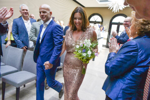 International wedding officiant with bride and groom leaving the Dylan Amsterdam, boutique hotel.