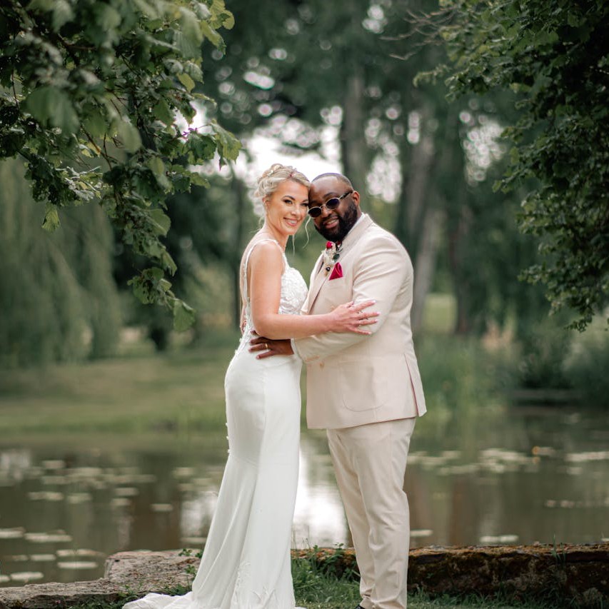 Vondelpark Wedding: A happy wedding couple celebrating their special day under a tree near a lake.