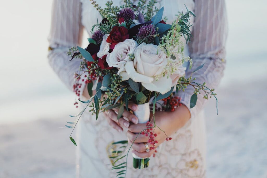 New Year's Wedding Woman holding a red and white rose bouquet.