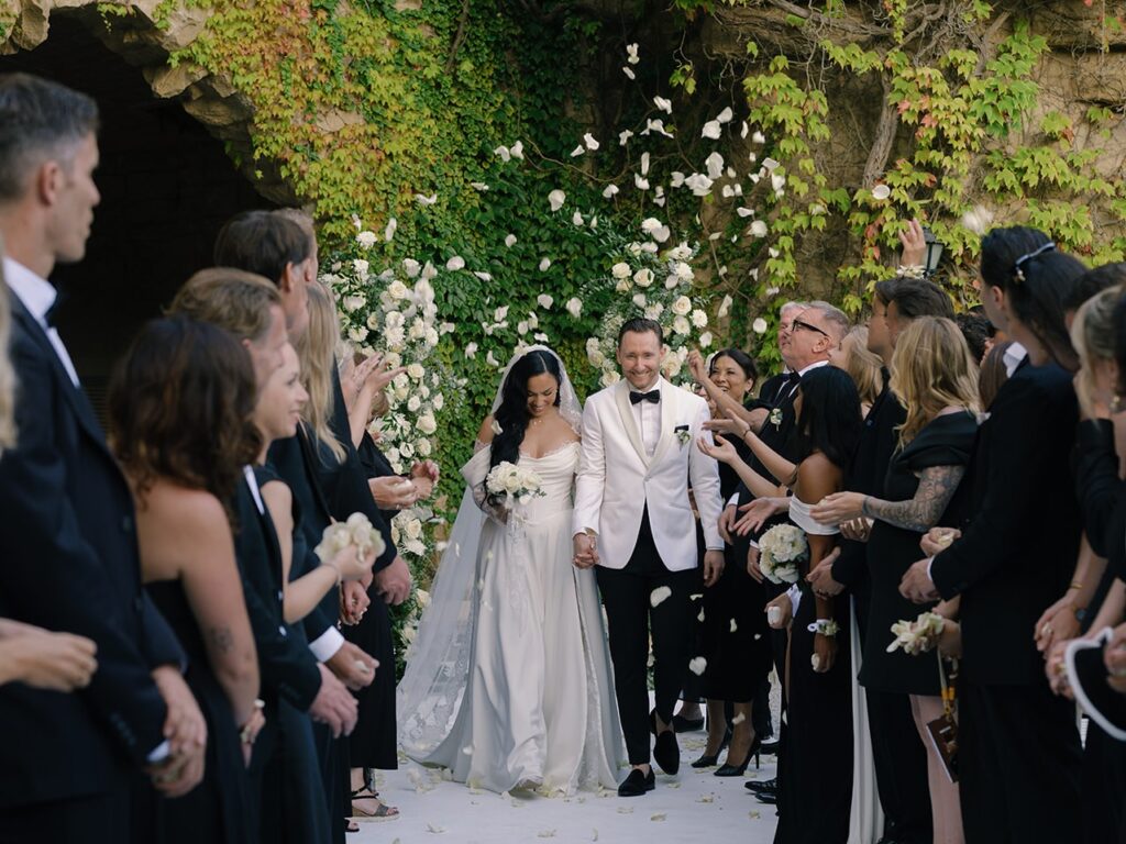 fusion wedding ceremony: international wedding officiant with bride and groom leaving La Baronia, Barcelona wedding venue.