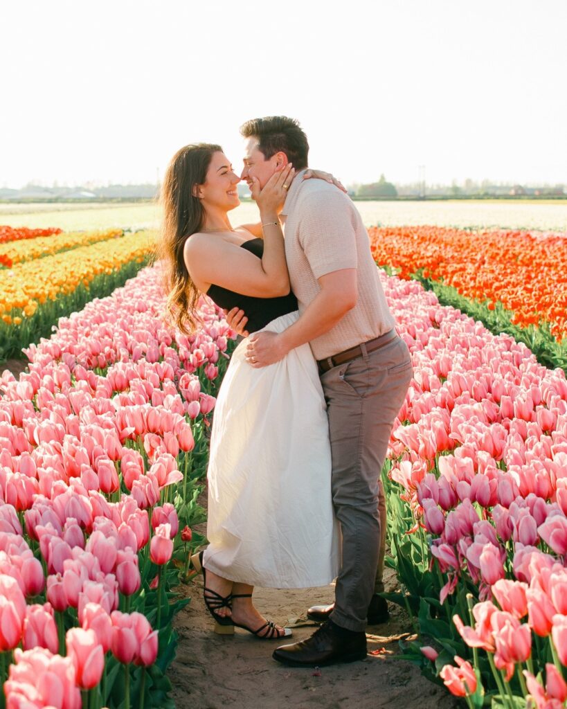 Spring marriage proposal Amsterdam couple hugging in a colourful tulip field after an event on the canals of Amsterdam.
