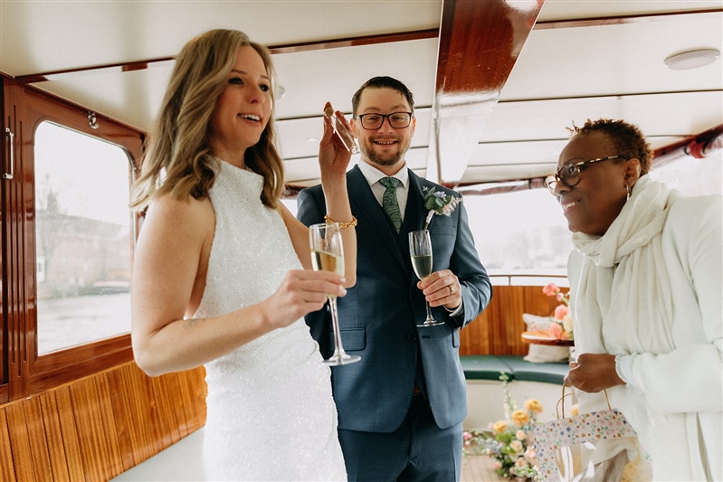 International couple during a destination wedding on the canals of Amsterdam.
